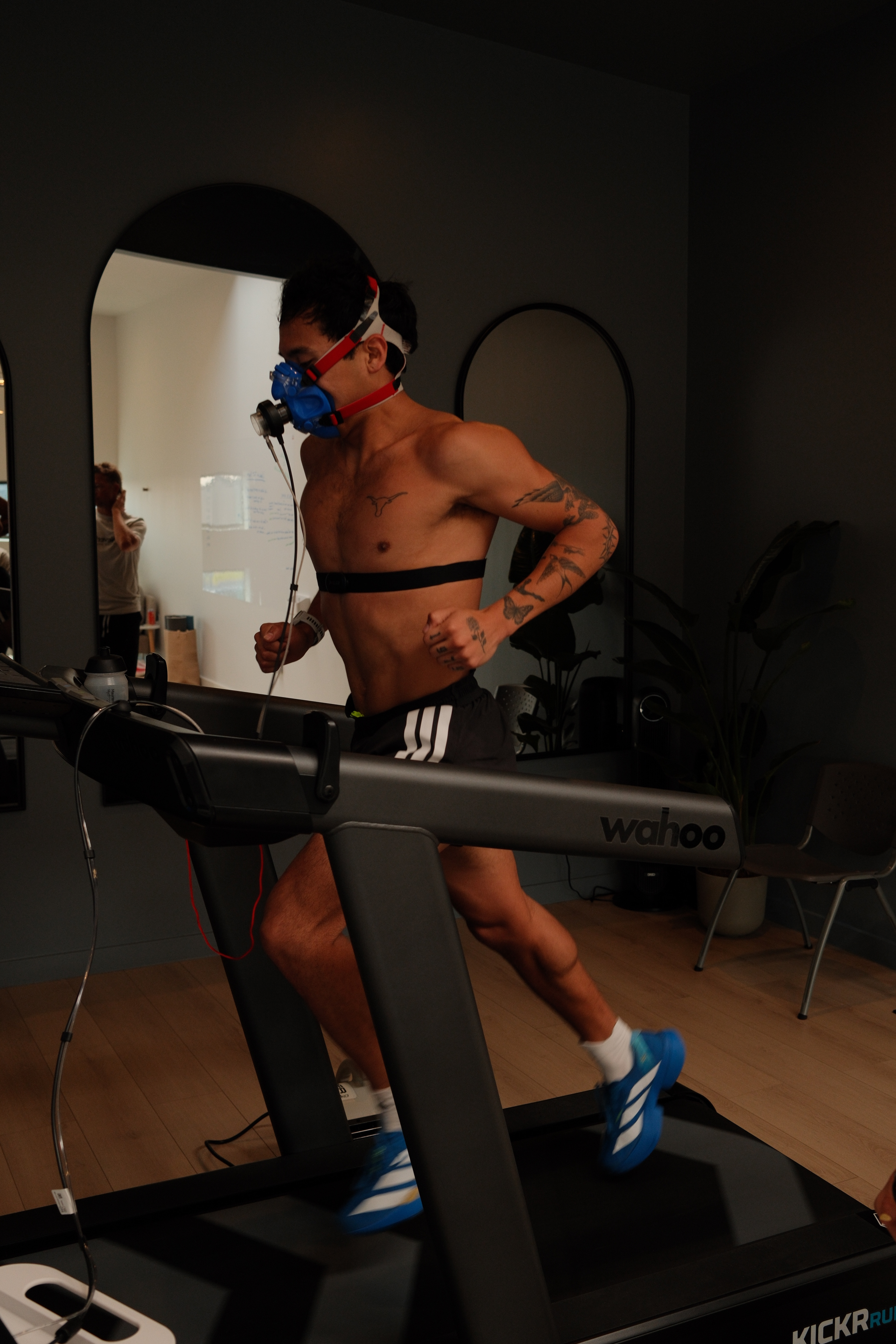 Athlete running a VO2 max test on a treadmill with a metabolic mask